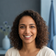 Portrait of a smiling South Asian woman in her late 20s or early 30s, looking confidently at the camera.